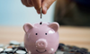 money being saved in a piggy bank